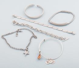 LOTE DE SEIS PULSERAS DE METAL PLATEADO Y ACERO. conjunto de seis pulseras, cinco en metal plateado y una de la marca Lotus en acero.