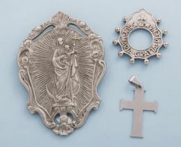 LOTE DE UN COLGANTE, UNA INSIGNIA Y ANILLO EN METAL PLATEADO. conjunto de colgante en forma de cruz, insignia con decoración religiosa y anillo de oraciones.